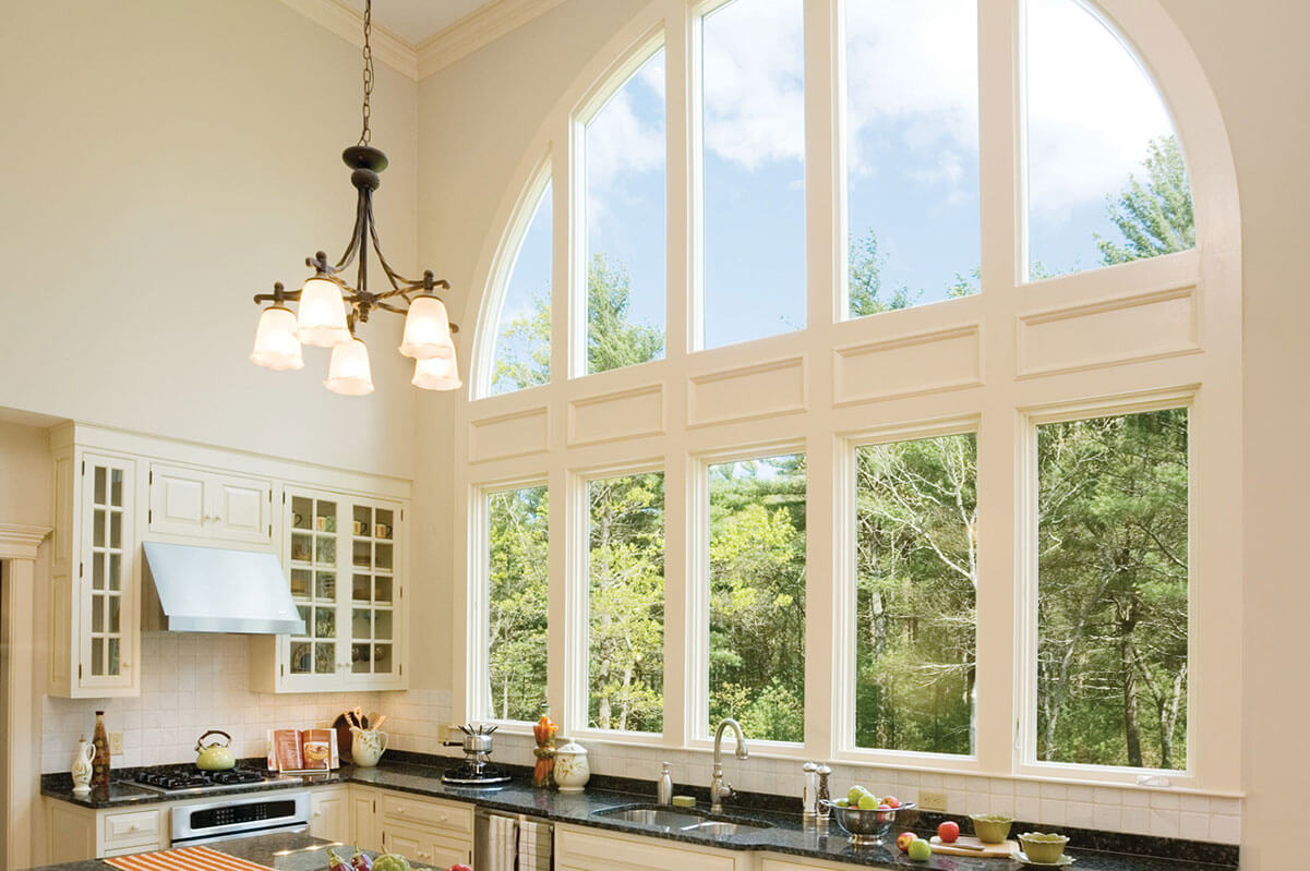 An architectural window in a kitchen letting in plenty of light.