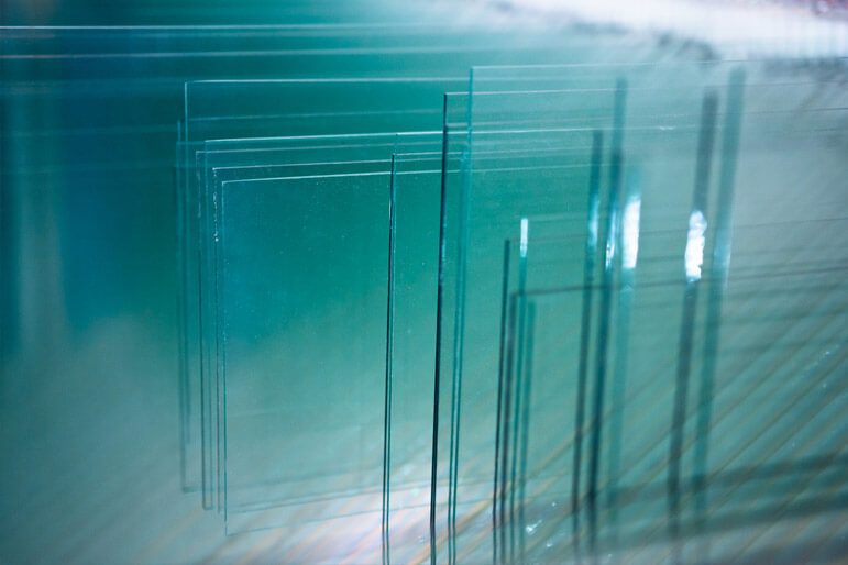 An elegant array of window panes giving off an aqua glow.