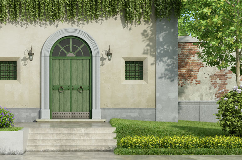 A vintage house set in the forest with a green door.