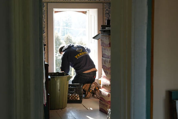 A Verdun installer puts in a bedroom window on the second storey of a vintage home.