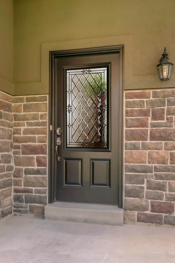 A light grey entry door with Canterbury glass inserts on a 2 panel blank top door slab.