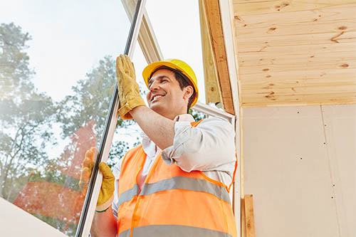 An image of a window installer installing a window.